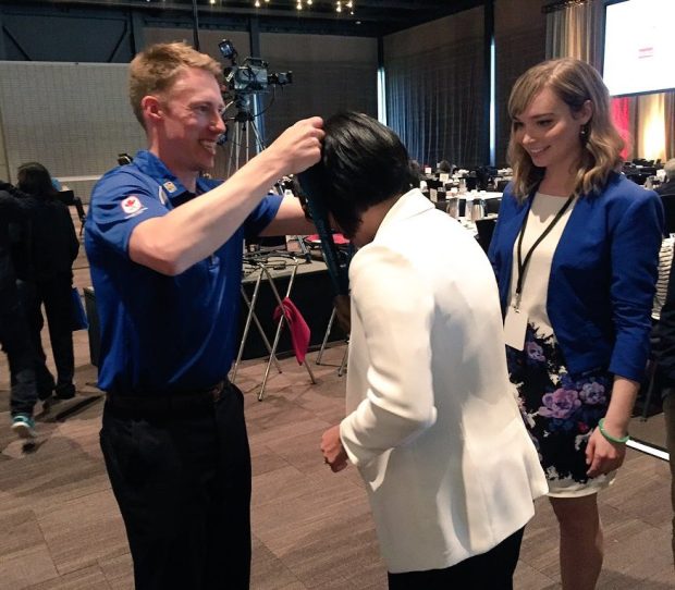 At the start of his speech, Kennedy told us that he considers his Olympic gold medal to be "everybody's medal" because of all the support his team got from Canadians - so he brings it to events and lets anyone who wants to hold it or try it on. Here he is, putting the medal on an audience member. (credit: @MacEwanBusiness) 